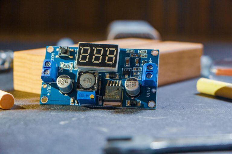 High-quality close-up of a digital electronic circuit board in a workshop setting.