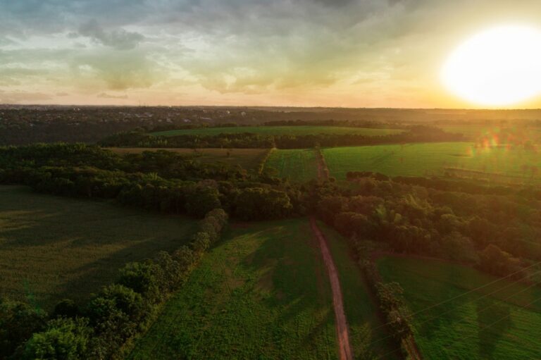 Aerial view of lush farmland and countryside during a vibrant sunset in Foz do Iguaçu, Brazil.