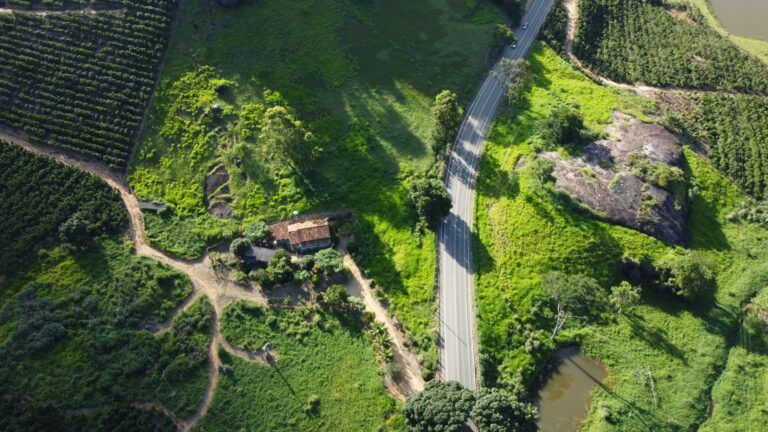 Scenic aerial view of farmland, road, and greenery in Águia Branca, Brazil.