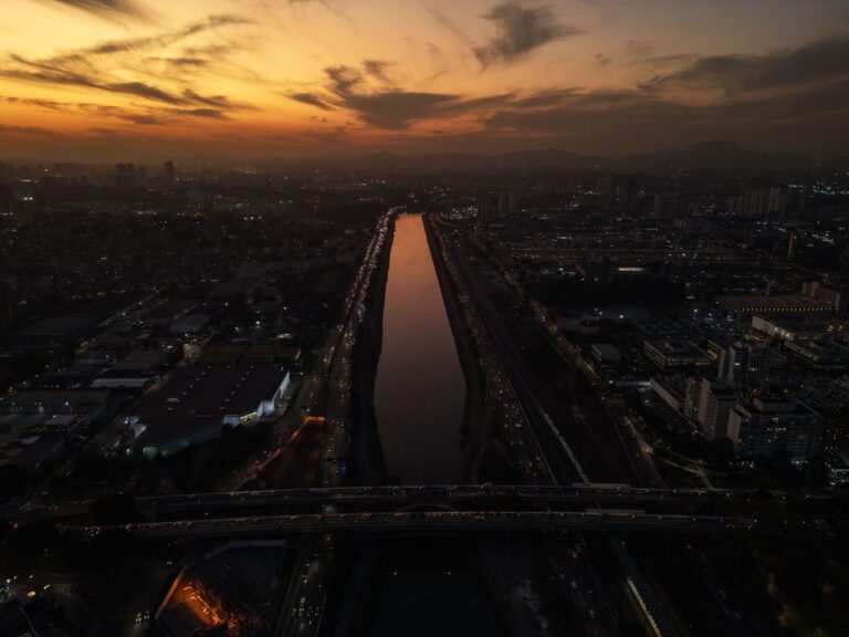 Captivating twilight shot of São Paulo with reflective river and urban skyline.